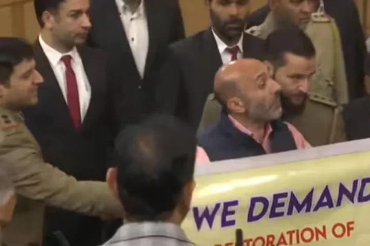 Engineer Rashid’s Brother Unveils Article 370 Banner in J&K Assembly, Sparking Tensions