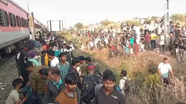 Jalgaon Train accidents scene showing damaged carriages and emergency response efforts.