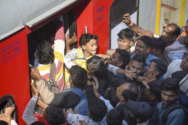 Image of a crowded railway station in India during a religious festival, highlighting the risk of stampedes due to overcrowding.