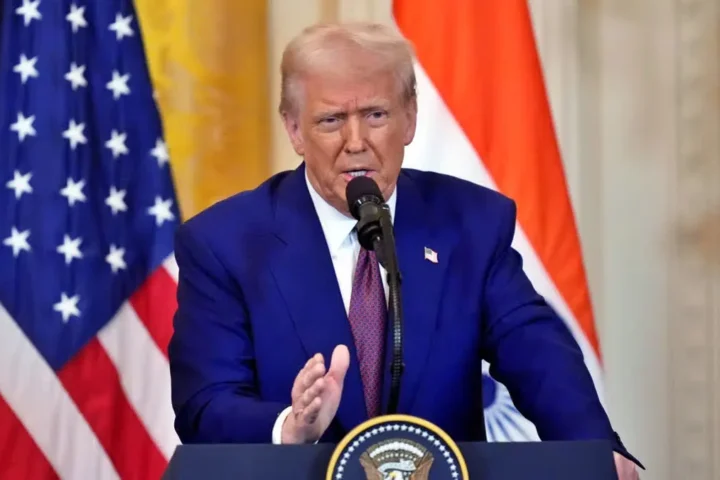 Donald Trump speaking at a rally, addressing USAID’s $21M funding for India’s voter turnout, highlighting concerns over foreign aid and trade policies.