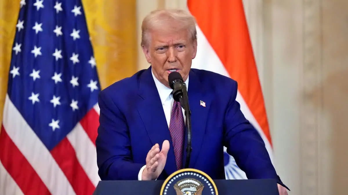 Donald Trump speaking at a rally, addressing USAID’s $21M funding for India’s voter turnout, highlighting concerns over foreign aid and trade policies.